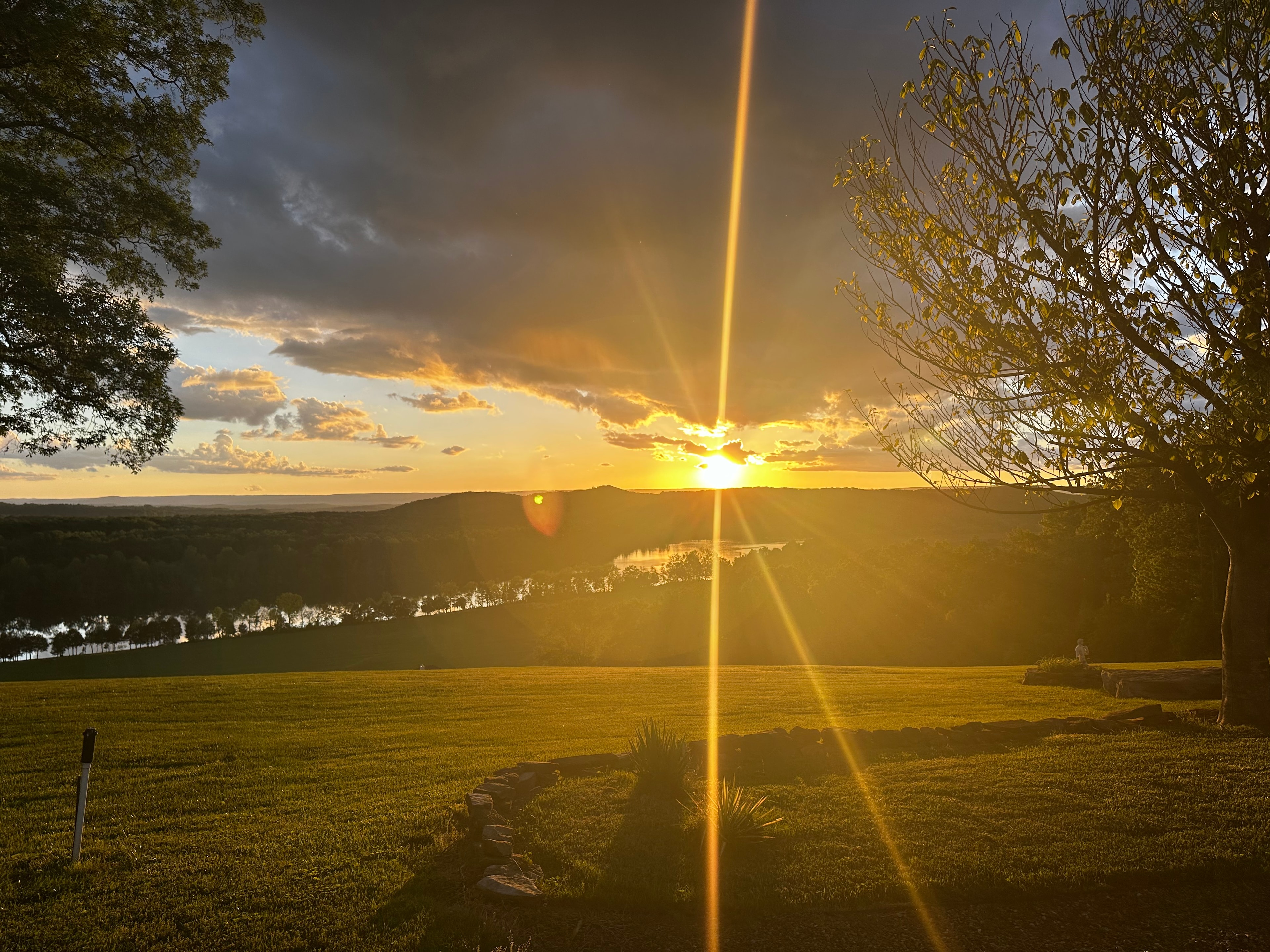 Golden sunset over a river valley with dramatic sky