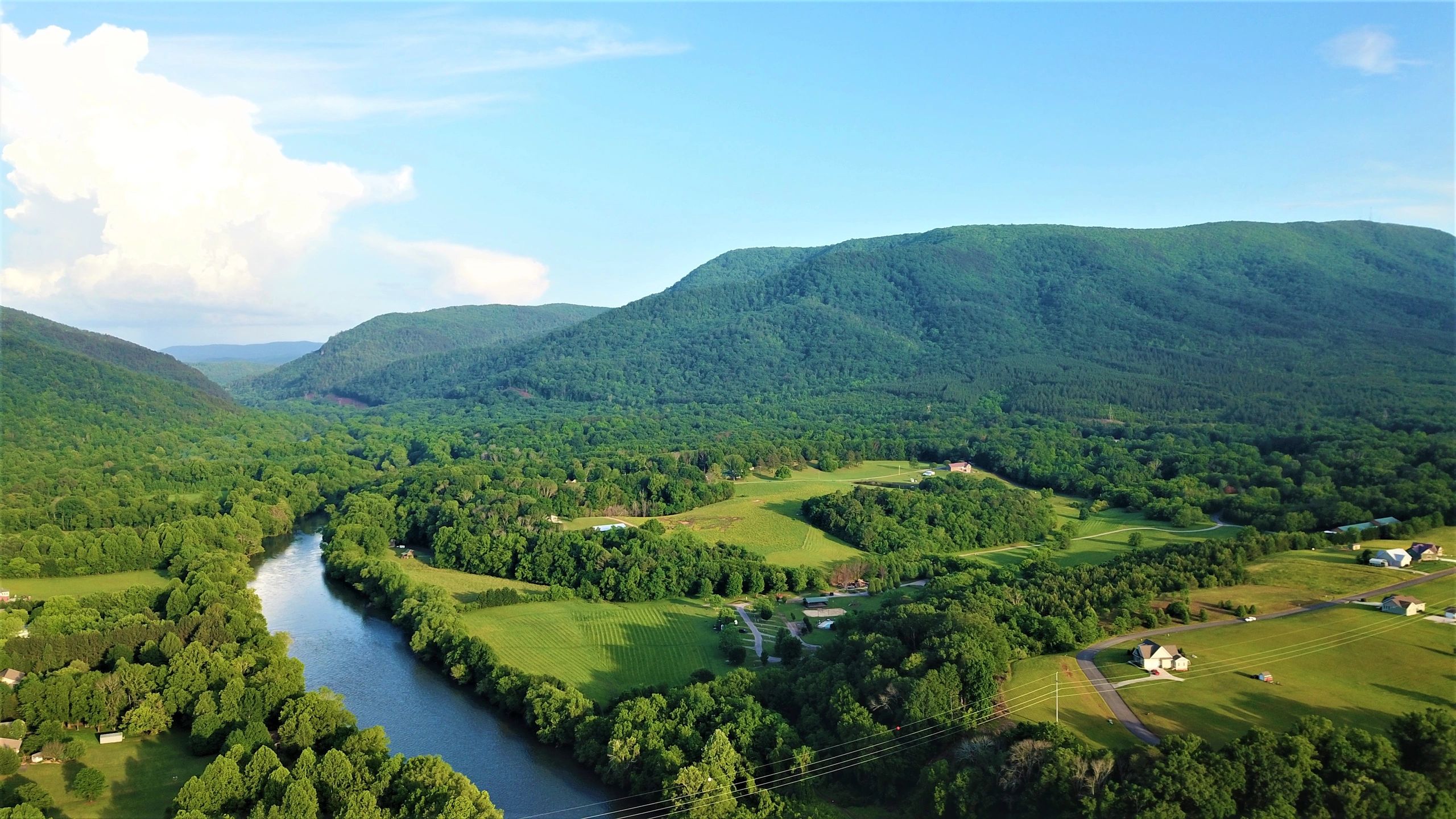Drone footage of Espalier Bay community lake and mountains